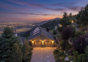 A house with a sloped roof, a garage, and a driveway leading to the entrance. - A beautiful spacious house on Summit (Crestline)