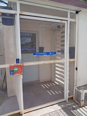 A gated entrance with a sign indicating an automatic door.