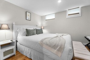 A bedroom with a bed, bedside tables, a bench, and a window. - Beach, Shop, Restaurants, Bike Path: 4 Min. to Town! Bikes & Beach Gear Included (Edgartown)