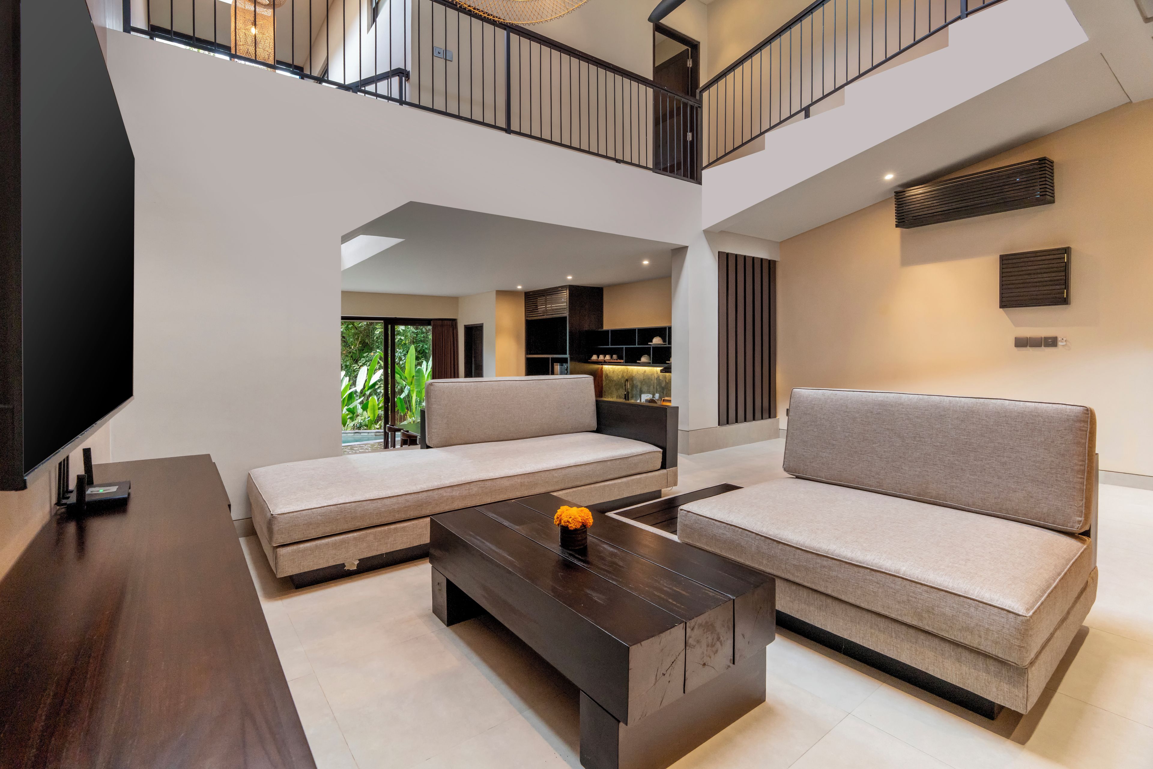 A modern living room with a sofa set, a coffee table, and a TV.