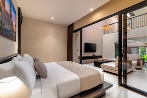 A modern bedroom with a bed, a TV, and a balcony with seating. - Emana Lumina (Ubud)