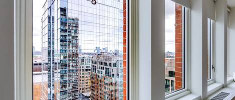 A modern building with large windows and a view of the cityscape.