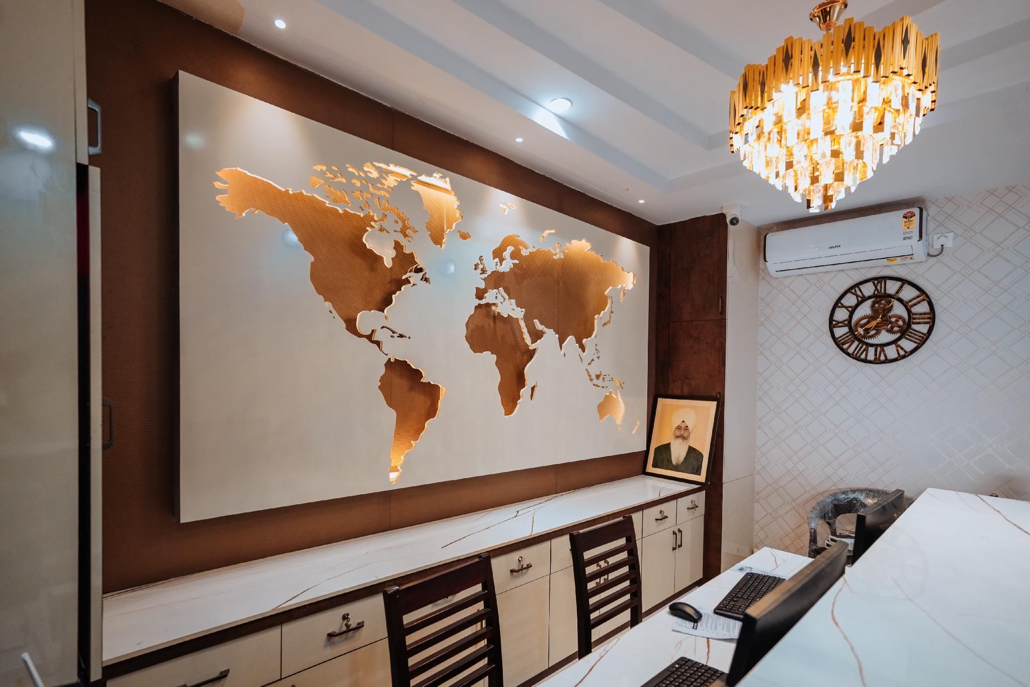 A modern office space with a large world map on the wall, a desk with a computer, and a decorative clock.