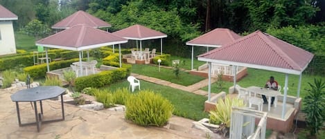 A patio area with outdoor seating and covered structures.