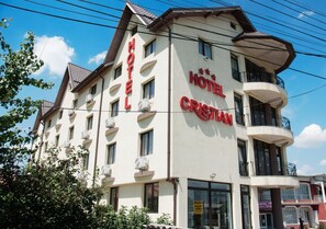 A multi-story hotel with a prominent sign reading 'HOTEL CRISTIAN.'