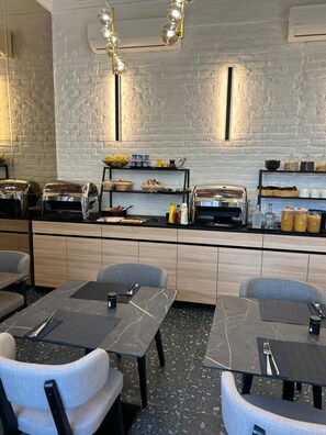 A modern restaurant with a brick wall, buffet counter, and seating area.