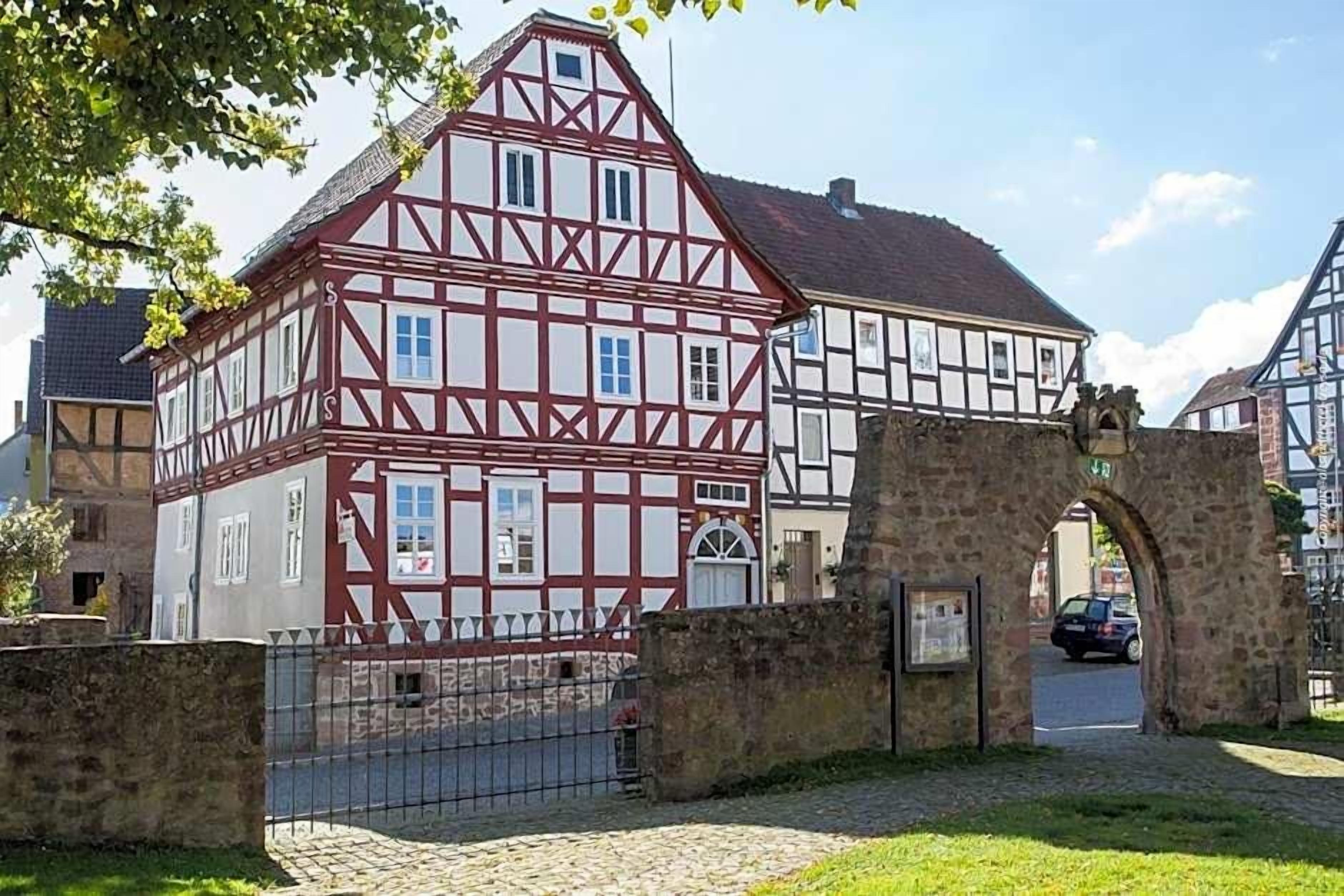 A traditional half-timbered building with a stone archway entrance.