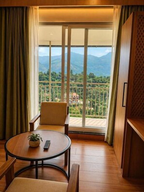 A room with a balcony, a round table, and a chair.