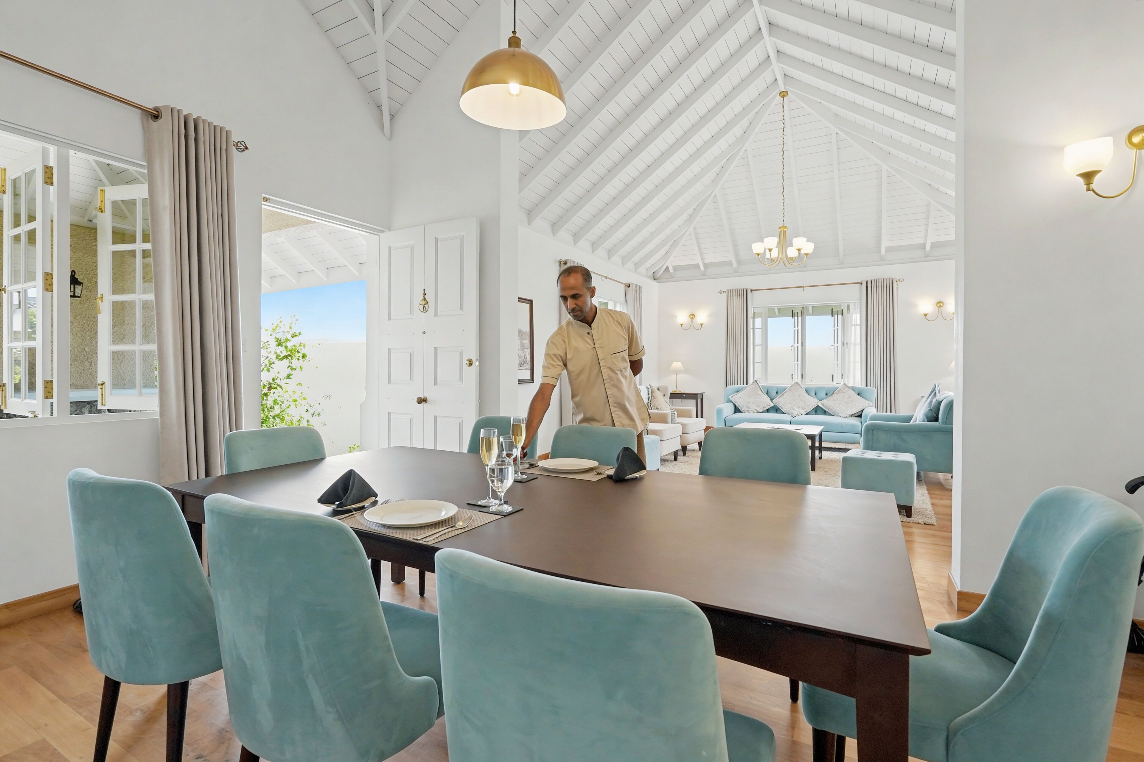A spacious dining area with a high ceiling and modern furniture.