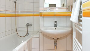 Un baño con bañera, lavamanos y ducha.