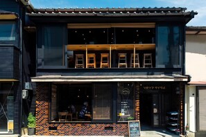 A two-story building with a cafe on the ground floor. - HITOYOI SENRI Rooftop BBQ Ocean View (Fukuoka)