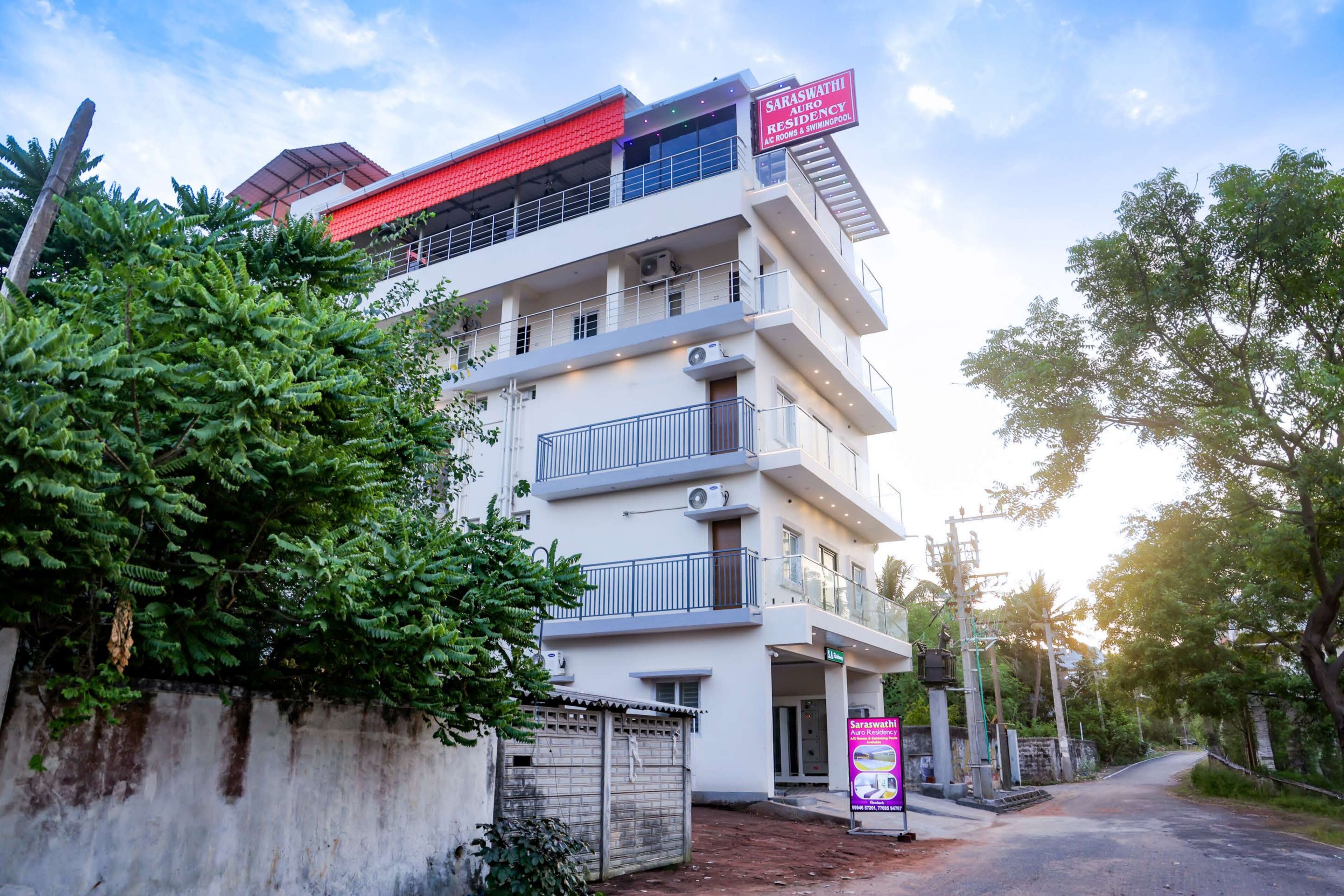 A multi-story building with balconies, a swimming pool, and a sign indicating it is a residence.