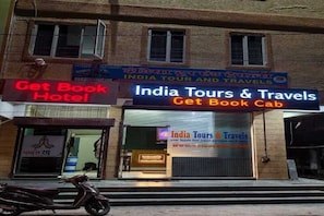 A building with signage for 'India Tours & Travels' and 'Get Book Cab'. - Get Book Hotel (Udaipur)