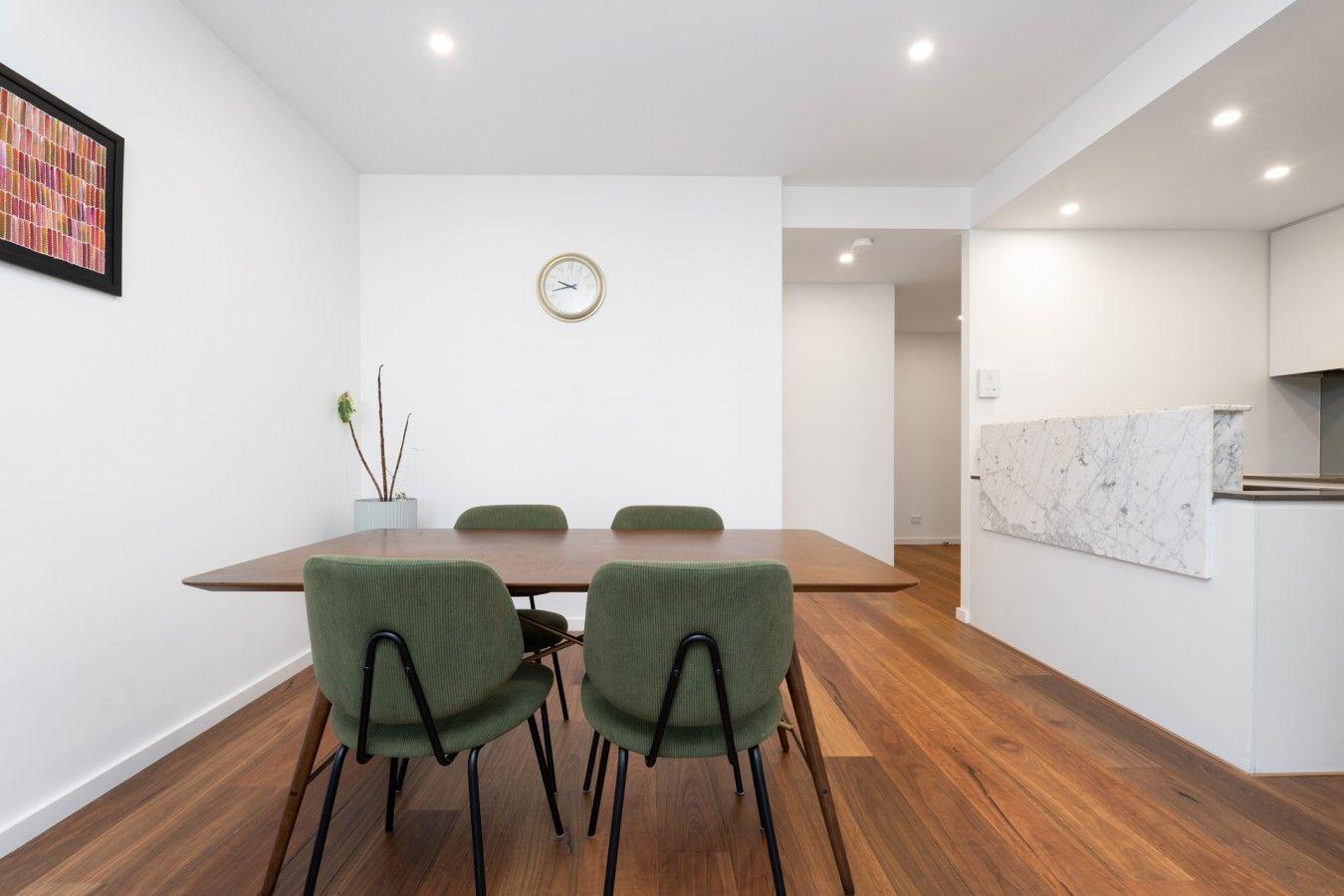 A bright dining area with comfortable seating and a simple, stylish setting, perfect for enjoying relaxed meals together.