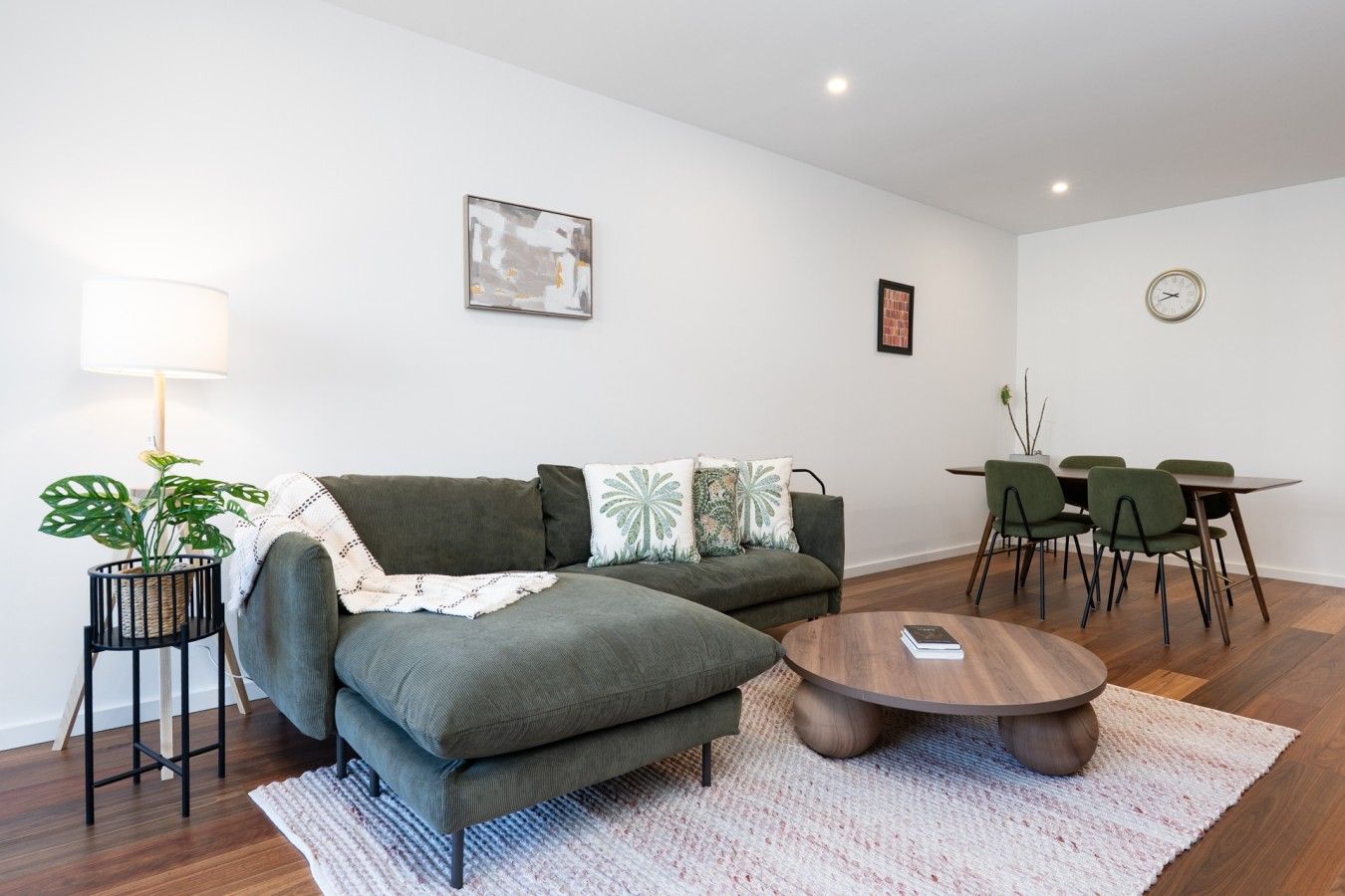 Settle into the comfortable living area, where cosy furnishings, timber flooring and natural light create a welcoming space to unwind.