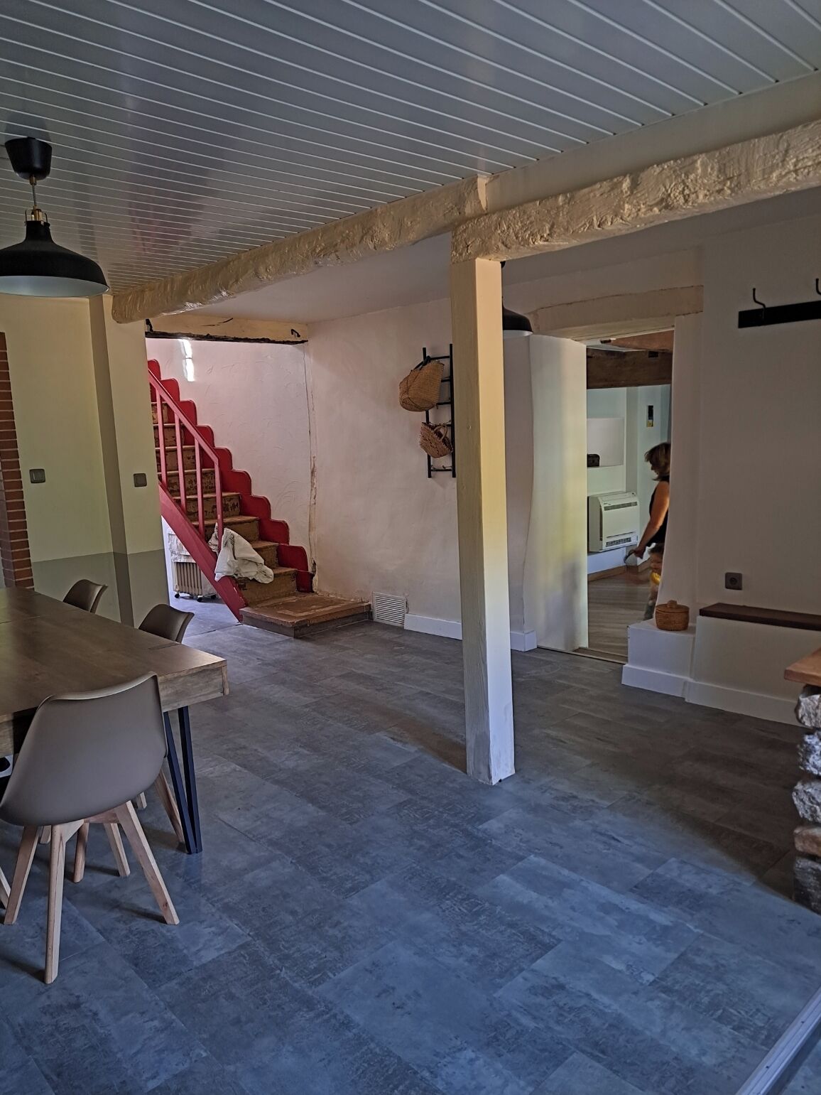 A spacious interior with a staircase, a dining area, and a kitchen.