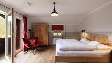 Ein Schlafzimmer mit Bett, Stuhl, Kleiderschrank und Fenster.