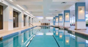 An indoor swimming pool with clear lanes, a starting block, and a lifeguard chair. - Oceanfront Daytona Condo | Balcony, Pool, Hot Tub (Daytona Beach)