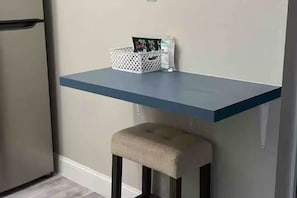 Una cocina con encimera azul, una cesta blanca y una botella de jabón de manos.