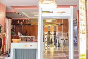 A hotel lobby with a reception desk, a water dispenser, and a view of the hotel's interior. - Villa Hilton Hotels and Apartments (Uyo)