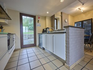 A compact kitchen with a sink, stove, and cabinets.