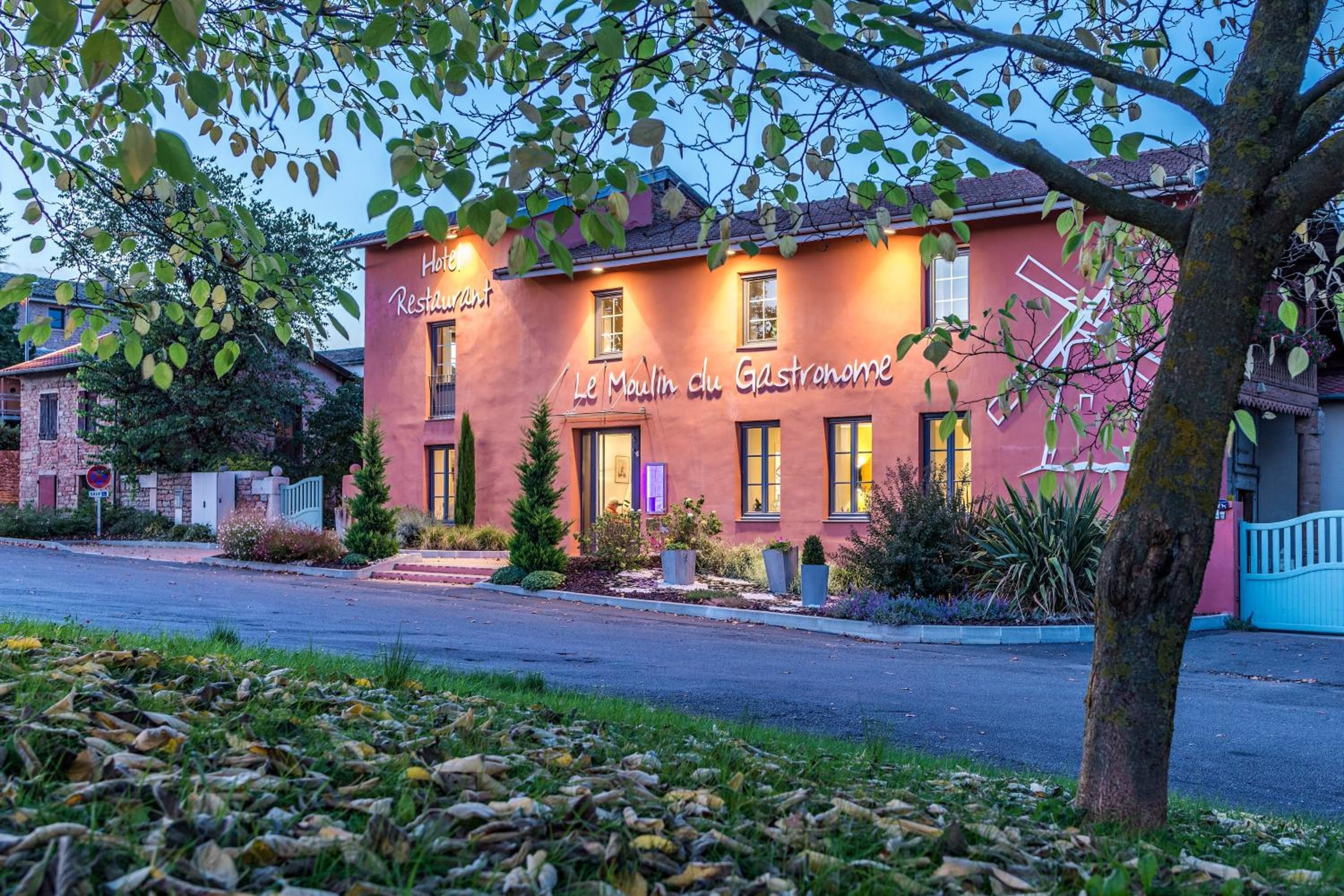 A two-story building with a sign that reads 'Le Moulin du Gastronomie.'