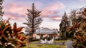 A house with a lawn and outdoor seating area. - The Homestead (Berry)