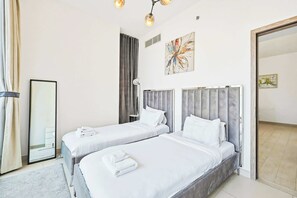 A hotel room with two beds, a large mirror, and artwork on the walls. - LIV Marina 2BR · City View · Beach 5min (Dubai)
