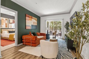 A modern living room with a sofa, a chair, a coffee table, and a large window. - Near NRG Stadium & DT| Pool & Gym, Free Parking (Houston)
