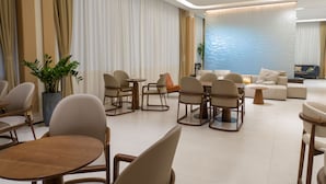A modern hotel lobby with a seating area, a coffee table, and a sofa. - Ebony Hotel (Douala)