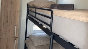 A bunk bed with a wooden wardrobe and a window. - Unique Houseboat near Amsterdam (20 min) (Monnickendam)
