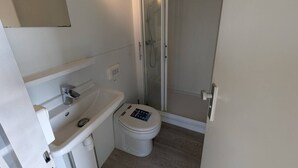 A bathroom with a toilet, sink, and shower area. - Unique Houseboat near Amsterdam (20 min) (Monnickendam)
