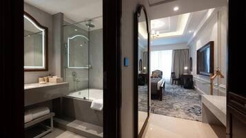 A modern bathroom with a glass-enclosed shower, a bathtub, and a vanity with a mirror.