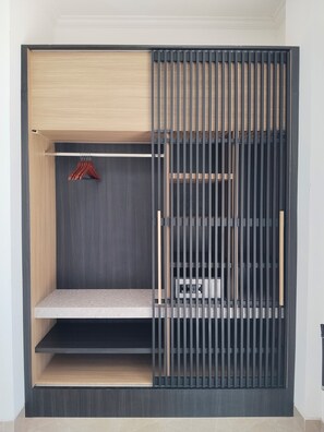 A modern wardrobe with multiple compartments, including hanging space and shelves.