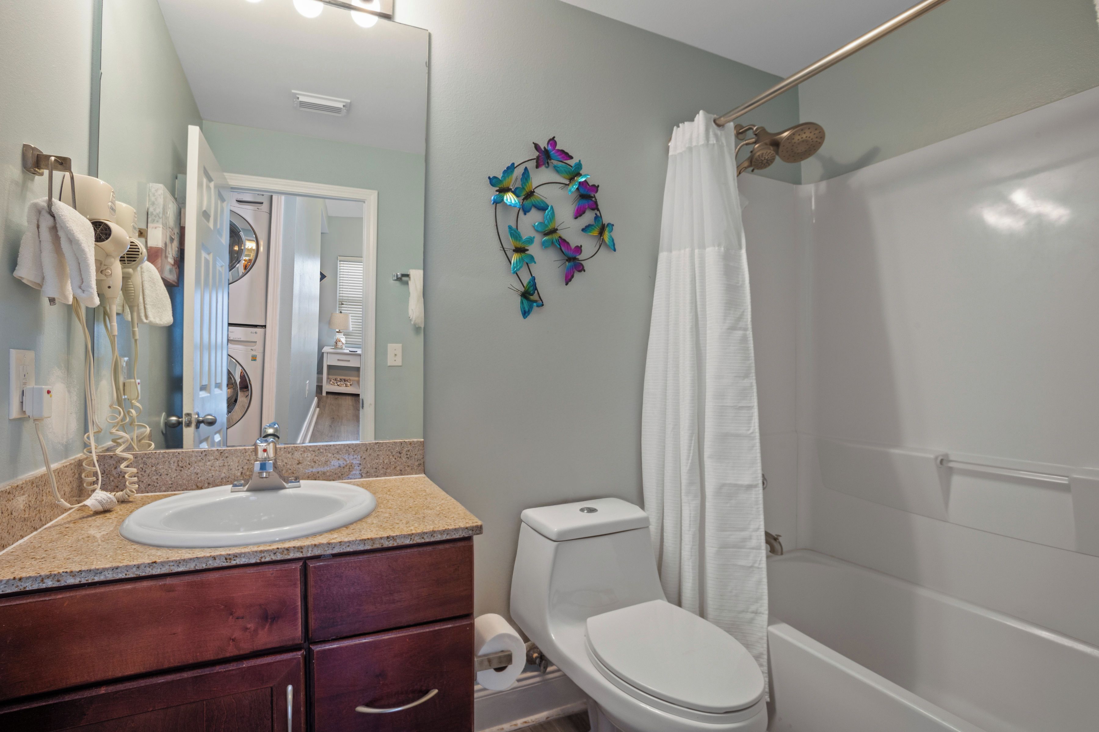 A bathroom with a sink, toilet, and shower.