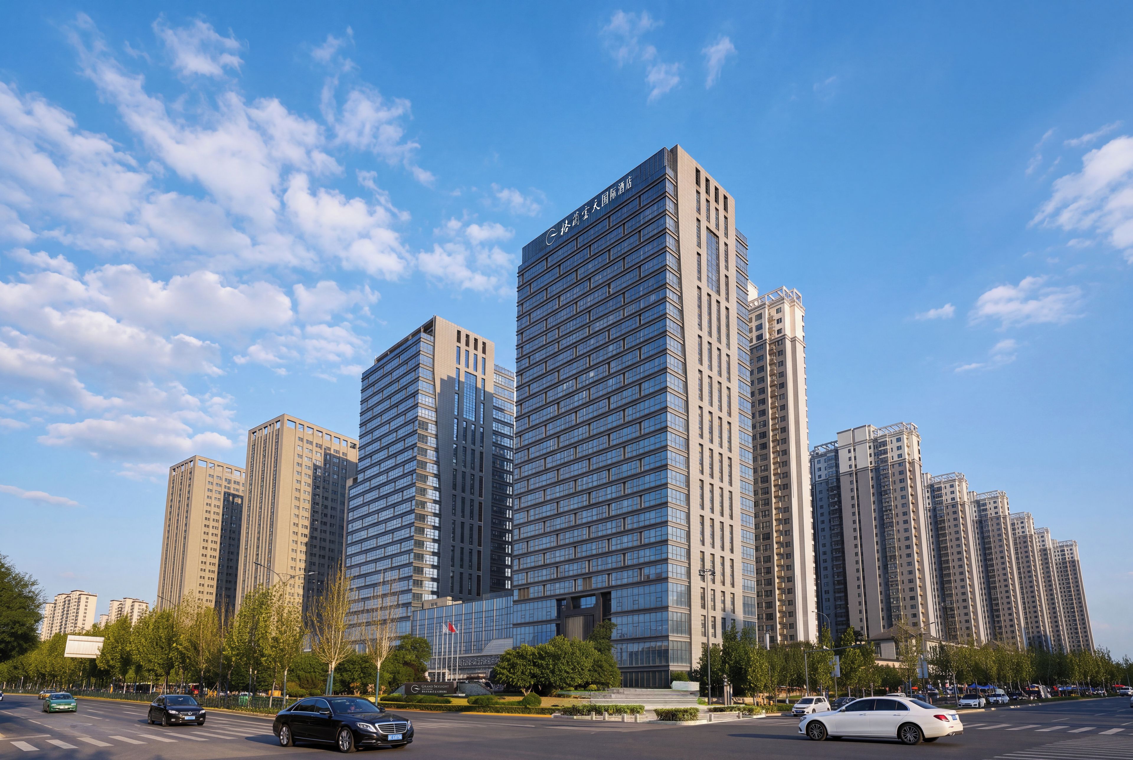 A modern high-rise building with multiple floors, large windows, and a prominent entrance.