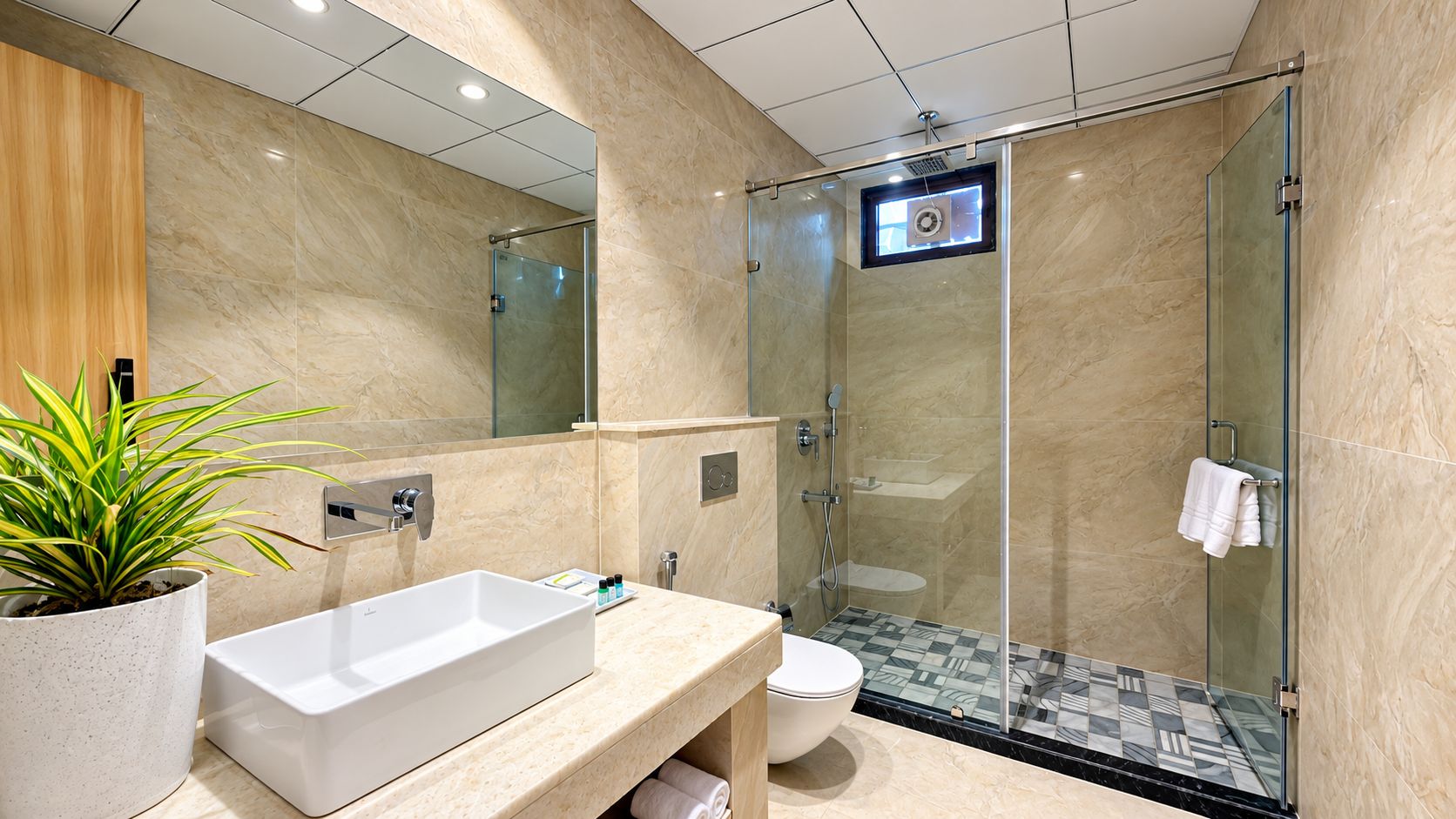 Un bagno moderno con un ampio lavandino bianco, un water e una cabina doccia in vetro.