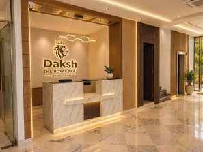 A reception desk with a logo and name 'Daksh The Royal Braj Vrindavan'. - Daksh The Royal Braj Vrindavan (Vrindavan)