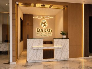 A reception desk with a marble top and a logo for 'Daksh The Royal Braj Vrindavan'. - Daksh The Royal Braj Vrindavan (Vrindavan)