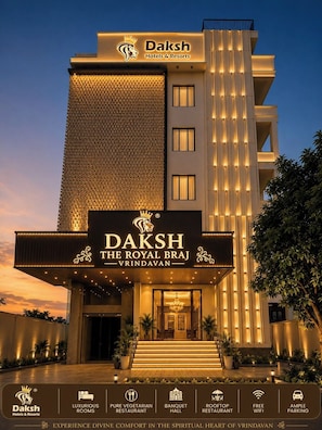 A hotel with a prominent sign reading 'Daksh The Royal Braj Vrindavan' and features include luxurious rooms, a pure vegetarian restaurant, a banquet hall, a rooftop restaurant, free WiFi, and ample parking. - Daksh The Royal Braj Vrindavan (Vrindavan)