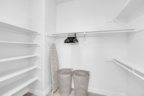 A white closet with shelves, a hanging rack, and two laundry baskets. - 5B3B Sweet Home｜Near Strip｜Perfect for Families (Las Vegas)