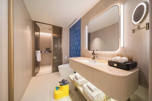 A modern bathroom with a large mirror, a sink, and a toilet. - Crystal Hotel Changde Wuling Pavilion  (Changde)