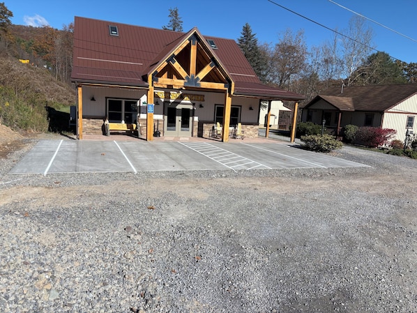 A building with a brown roof and a 'Welcome Center' sign.