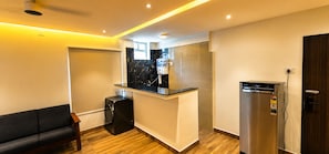 A compact kitchen with a built-in oven, a dishwasher, and a refrigerator.
