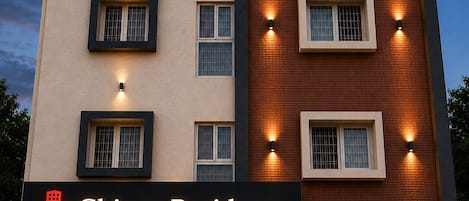 A multi-story building with a sign reading 'Chippy Residency Thoraipakkam.'
