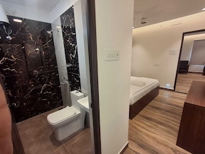 Un baño moderno con inodoro, lavabo y ducha.