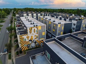 A multi-story residential building with a rooftop patio area. - Open-Concept Design + Game Stash | Mins to Five Points | Harmony House (Nashville)