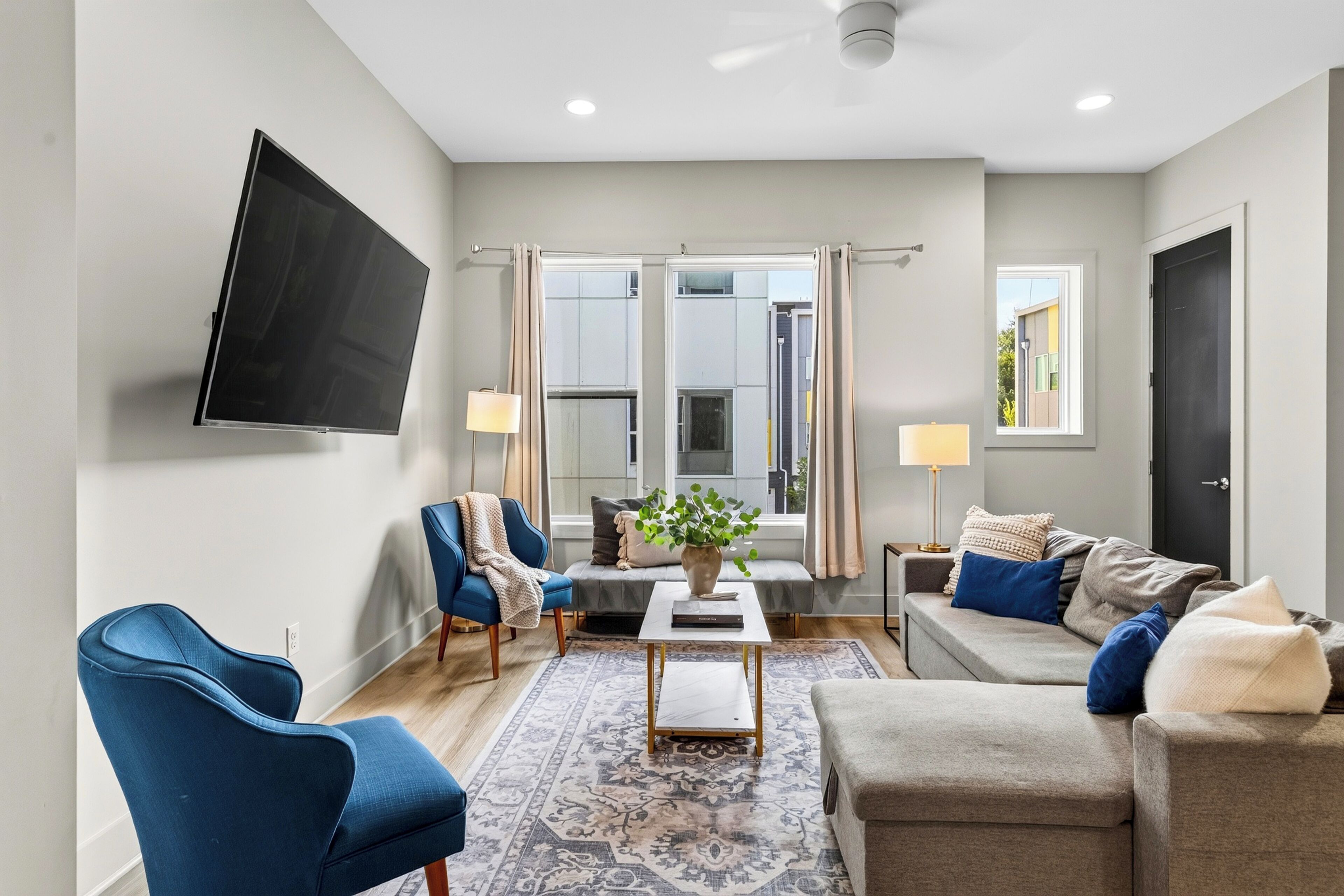 Open living room with a sectional and mounted TV