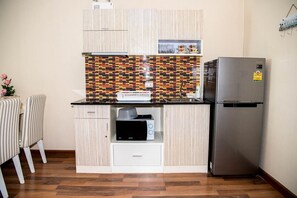 A compact kitchen with a microwave, toaster, and refrigerator. - E609 Spacious 3-bedroom apartment in terrific with Playground near Beach (Nongkae)