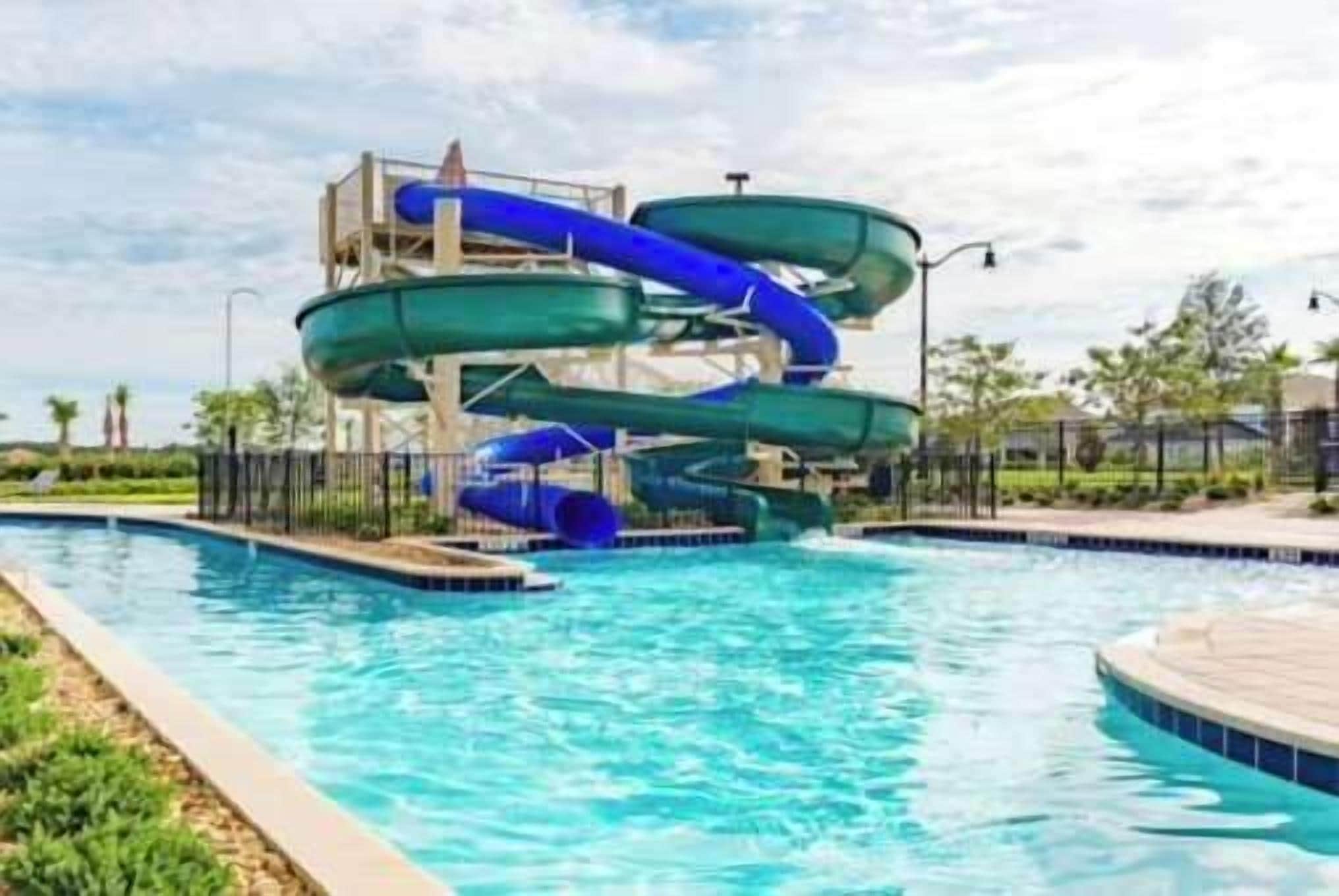 A swimming pool with a water slide structure.
